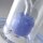 \Glas-Bong-Detailaufnahme mit transparentem Korpus und blauem Perkolator mit Noppenstruktur im Inneren, auf runder Glasbasis.\